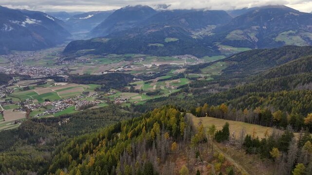 4k aerial landscape video footage, flying and panning left across the Puster Valley with Bruneck the largest city, located in the middle of the wide valley in the Italian province of South Tyrol