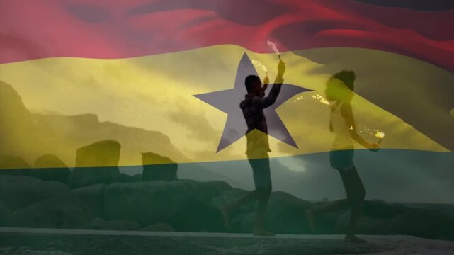 Dancing with fire, silhouetted performers in front of Ghana flag animation backdrop