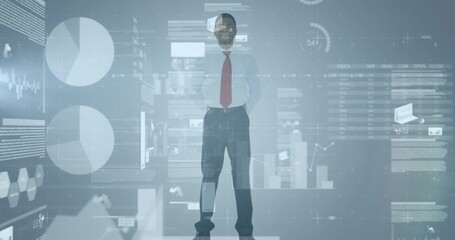 Statistical data processing over african american businessman standing against grey background - Powered by Adobe