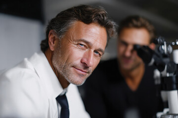 A confident researcher examines samples in a modern laboratory, reflecting the critical role of research and science in advancing knowledge and breakthroughs.