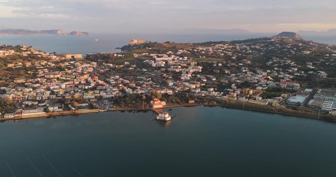Aerial view of Casina Vanvitelliana standing proudly on the lake's surface, surrounded by lush greenery and calm waters, Fusaro Lake, Bacoli, Italy.