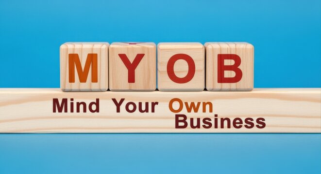 MYOB wood blocks, business advice, and positive thinking concept on a blue background, asking to mind your business