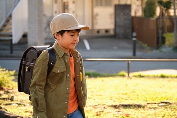 Japanese elementary school student walking to school, wearing a randoseru backpack