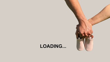 Expecting Parents Holding Baby Shoes with Loading Text