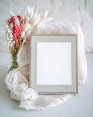 Elegant wedding card mockup with soft textures and natural decorations set against a serene background