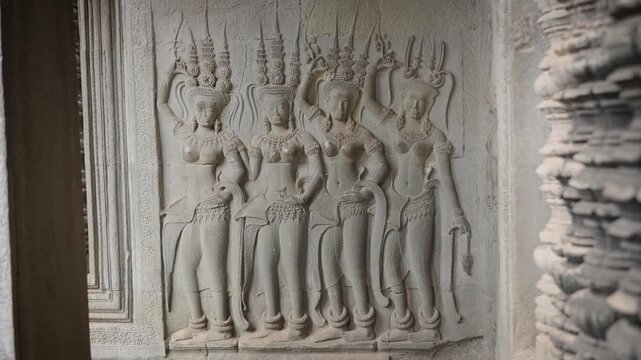 SIEM REAP, CAMBODIA - OCTOBER 27, 2025: Ancient Apsara Bas-Relief Carvings on Walls of Angkor Wat, Cambodia. Detailed 4K editorial footage  this UNESCO World Heritage Site.