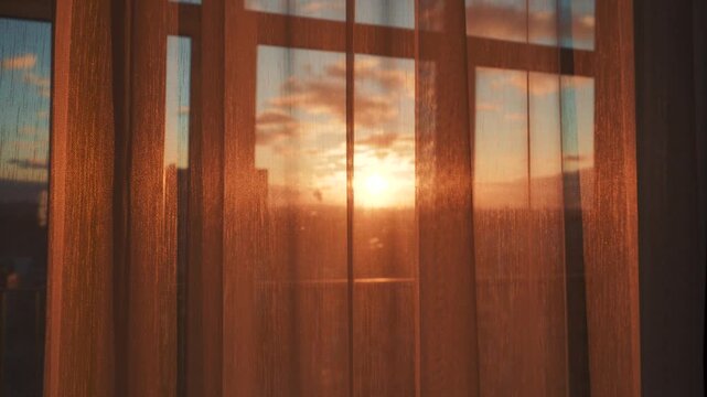 Sunset light gently fills rooms. Twilight casts glow on indoor spaces. Evening glow softly highlights interior and creates welcoming shades. Shine through window through transparent tulle