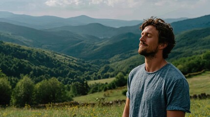 Naklejka premium Young man breathes calmly amid greenery concept. Man enjoying nature in a serene mountain landscape.