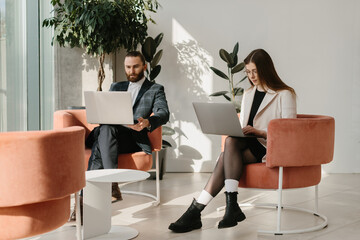 Business professionals working with laptops in modern office