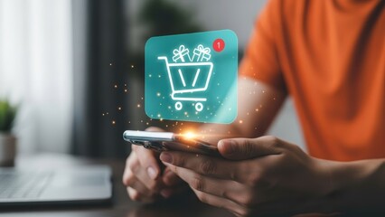 Person holding smartphone with glowing digital shopping cart hologram and notification for mobile e-commerce and online shopping concept