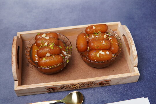 Lamba jamun is a traditional Indian sweet dessert made from milk solids, shaped into elongated forms, deep-fried, and soaked in fragrant sugar syrup. Soft, juicy, and rich in flavor, this popular swee