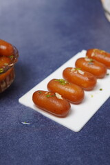 Lamba jamun is a traditional Indian sweet dessert made from milk solids, shaped into elongated...