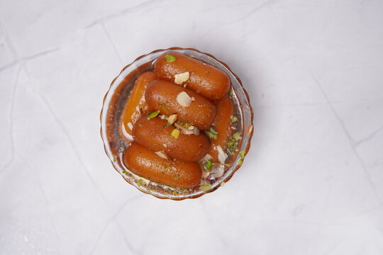 Lamba jamun is a traditional Indian sweet dessert made from milk solids, shaped into elongated forms, deep-fried, and soaked in fragrant sugar syrup. Soft, juicy, and rich in flavor, this popular swee