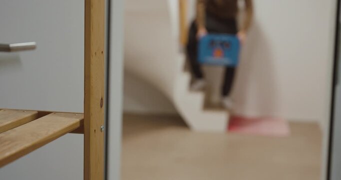 A man struggles while carrying a heavy beer crate and bends forward in discomfort. The scene highlights everyday lifting tasks, physical overload, and the risk of lower back pain caused by improper mo