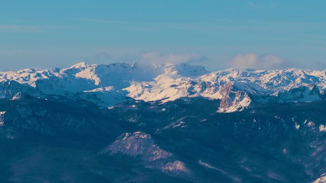 Aerial panorama of Maglic mountain peaks covered in snow, showcasing highest alpine terrain and remote winter wilderness of Bosnia