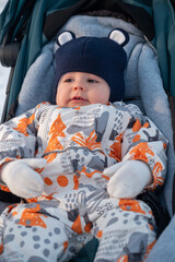 Baby in Stroller Enjoying Winter Outdoors.