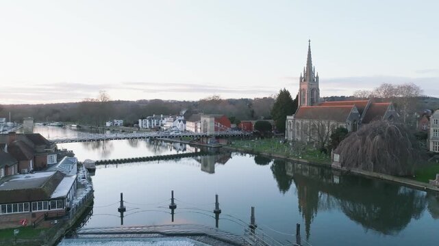 Marlow, UK Sunset static over the river at sunset looking at town bridge with cars.