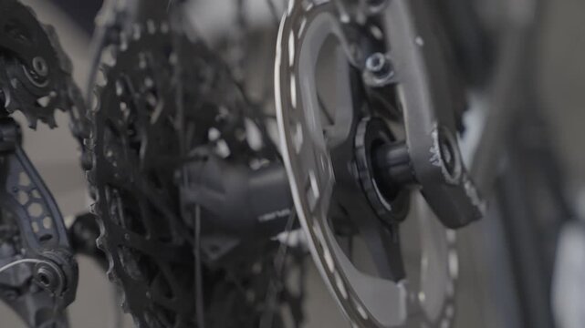 close view of bicycle drivetrain gears and chain moving in slow motion