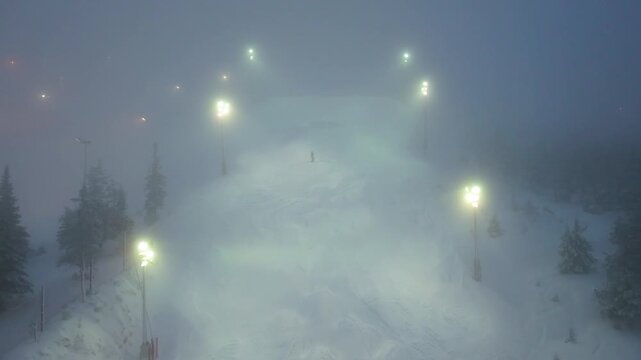 4K cinematic drone footage of Ruka, Finland, showcasing the winter ski resort, snow-covered slopes, and surrounding Arctic wilderness_42