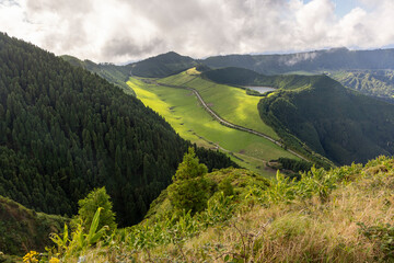 A mountain range with a lush green valley in between at Sete Cidades, Azores