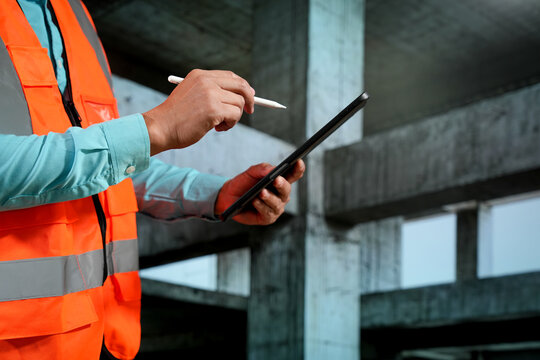 Civil engineers inspect building construction projects, checking the structural integrity and safety measures.