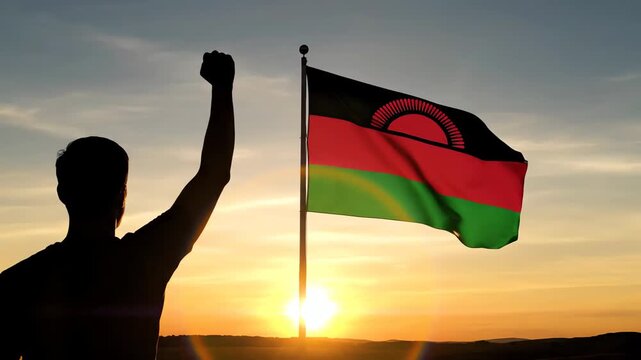Malawi flag waving with man celebrating independence at sunrise