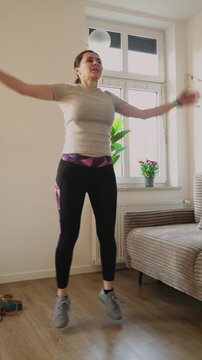 Woman Doing Jumping Jacks During Home Training, Vertical Video