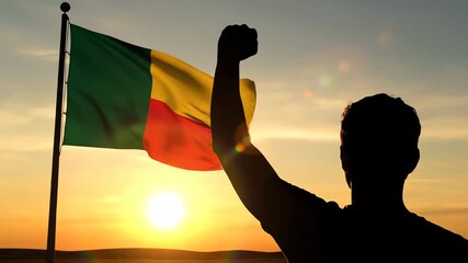 Man Celebrating Benin Independence Day with National Flag at Sunset