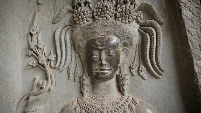 SIEM REAP, CAMBODIA - OCTOBER 27, 2025: Ancient Apsara Bas-Relief Carvings on Walls of Angkor Wat, Cambodia. Detailed 4K editorial footage  this UNESCO World Heritage Site.