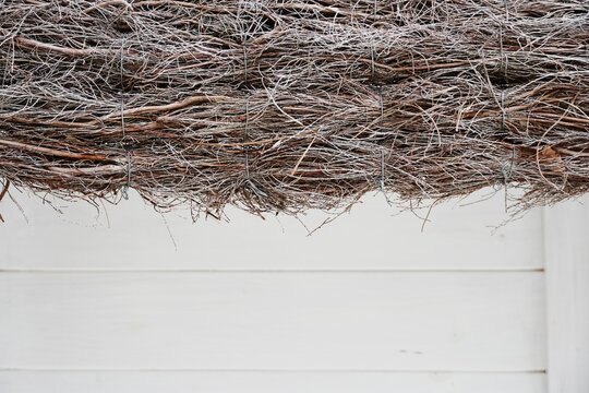Natural heather brushwood texture. Decorative dry branches on white wood surface with copy space.