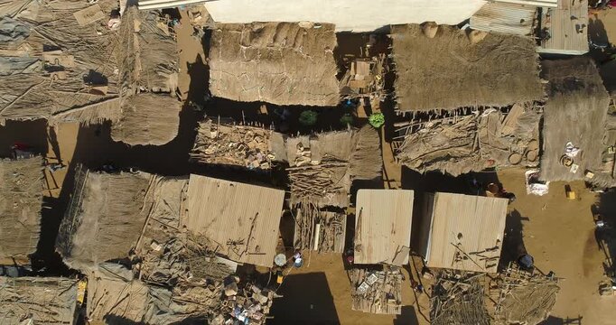 Aerial view of thatched rooftops, and sandy buildings, creating a textured mosaic under the sun, defining the unique landscape, Tete, Tete Province, Mozambique.