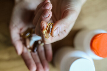 Supplements, dietary supplements, pills, vitamins. Woman takes supplements, BADs to improve her...