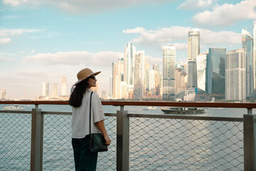 Dubai Marina skyline at golden hour with a tourist watching the sunset