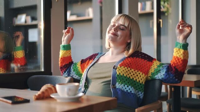 plus-sized woman relaxing at cafe in the morning