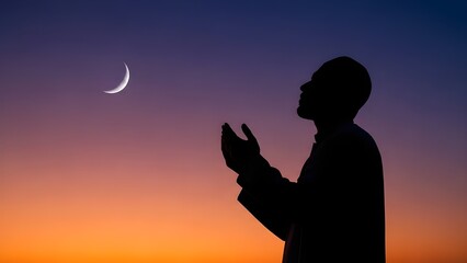 Silhouette of a Muslim Man Praying Dua with Hands Raised Under a Crescent Moon at Sunset