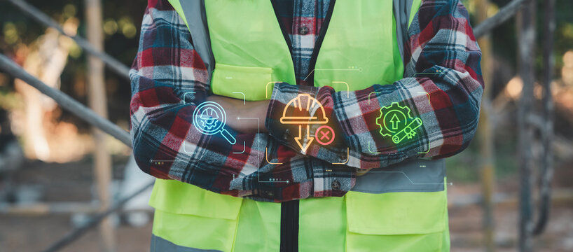 Construction worker with crossed arms using digital icons to analyze labor shortage crisis and search for skilled workforce training solutions, Recruitment, Growth, Education, Qualification concept