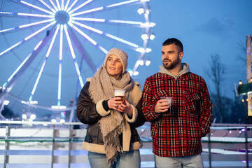 Couple celebrating winter fun at amusement park