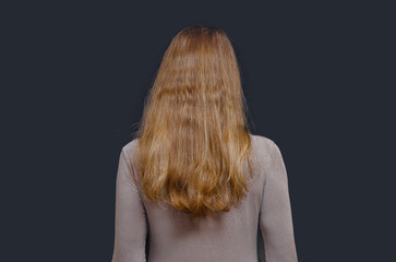 Naklejka premium Back view of woman with long natural fair hair, healthy texture and minimalistic beauty concept.