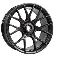 Obraz premium A close-up shot of a carbon fiber wheel, showcasing its intricate design and sleek aesthetic
