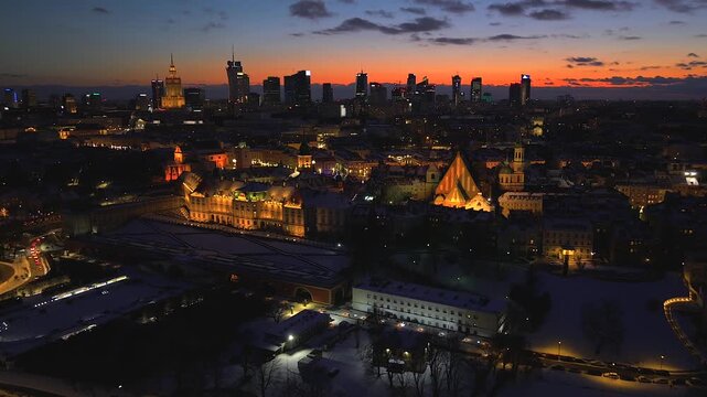 Aerial view of plac Zamkowy and cityscape with building lights contrasting against the dark sky, creating a captivating urban panorama, Warszawa, Wojewodztwo mazowieckie, Poland.