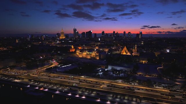 Aerial view of plac Zamkowy against the skyline, with the buildings reflecting the glowing sunset in a captivating urban landscape, Warszawa, Poland.