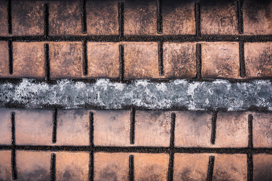 Aerial view of weathered terracotta roof tiles, divided by a band of silver, creating a textured tableau of aged beauty, Santa Cruz de La Palma, Canarias, Spain.