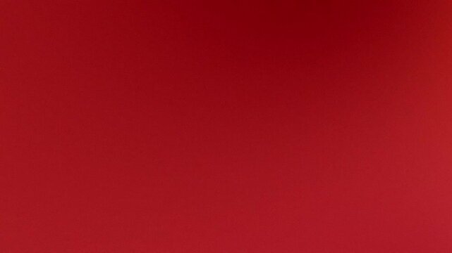 Solid deep red abstract textured background with smooth gradient for design and advertising