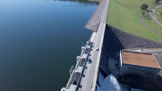 Aerial Tracking Shot Of A Car Driving Over J. Percy Priest Dam And Reservoir Spillway Bridge In Tennessee, USA.