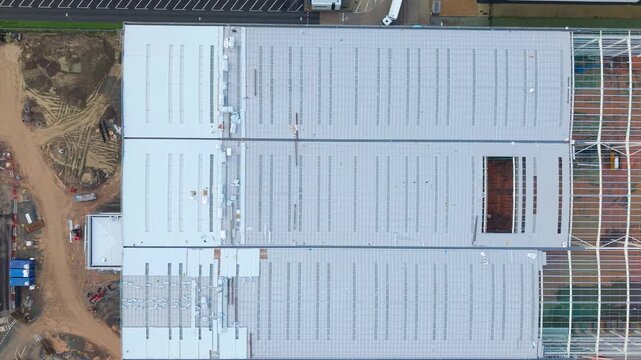 Aerial drone close up of a new build industrial warehouse construction site in the UK.