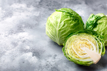 Obraz premium Fresh green cabbage with a halved piece on a textured surface Generative AI