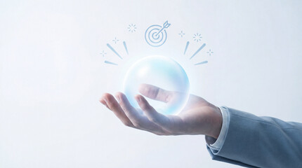 Hand holding glowing crystal ball symbolizes focus and future goals, with target icon above representing precision and success. image conveys sense of clarity and determination