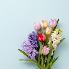 Obraz premium Vibrant spring bouquet with mixed tulips and hyacinths on light blue background