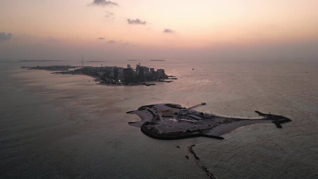 Maafushi, Maldives: Aerial drone footage of dramatic sunset over small island and Maafushi, islands in Kaafu Atoll of Maldives. 