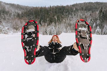 Woman in Snowshoes Having Fun in Snowy Landscape